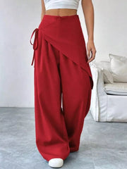 Red high-waisted wide-leg maternity pants with a wrap-style front and tie detail.