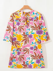 Print bell sleeve mini dress with colorful floral pattern and tie back.