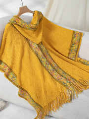 Mustard knit hooded wrap with diamond pattern and colorful embroidered trim.
