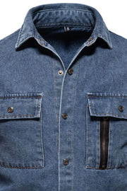 Light blue denim shirt with buttoned chest pockets, one featuring a zip detail.