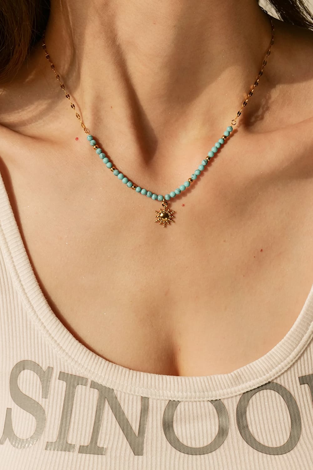 Gold celestial sunburst beaded necklace with turquoise beads