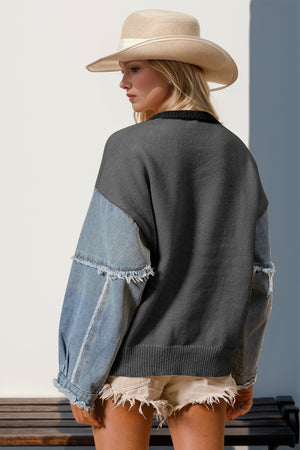 Dark gray knit sweater with denim sleeves featuring frayed details.