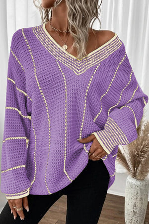 Lavender knit oversized V-neck sweater with cream trim and vertical stripe detail.