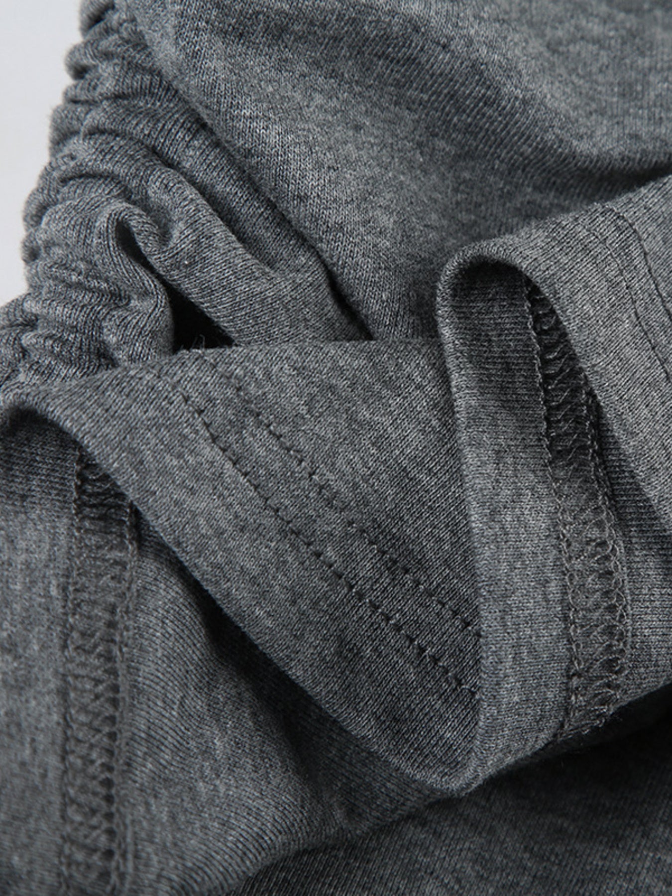 Ruched grey bodycon mini dress detail showing drawstring and stitching