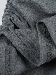 Ruched grey bodycon mini dress detail showing drawstring and stitching