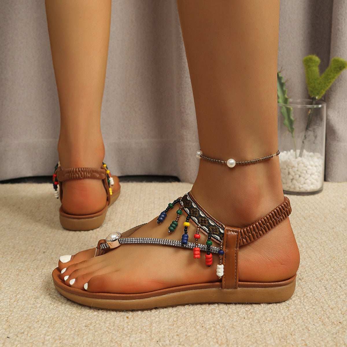 Tan bohemian ankle strap sandals with colorful beads and a pearl anklet.