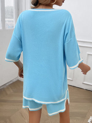 Pastel blue knit loungewear set with white contrast trim on neckline, sleeves, and shorts.