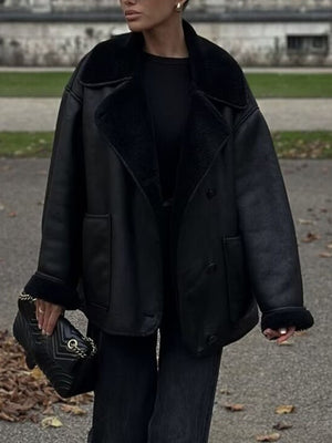 Black oversized aviator jacket with shearling trim and collar, buttoned front, and cuffed sleeves.