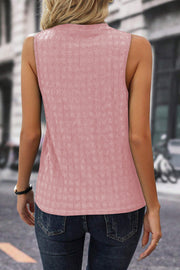 Dusty pink textured sleeveless blouse with a mock neckline.