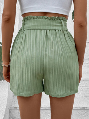 Light green pleated high-waist belted bermuda shorts with a paperbag waist.