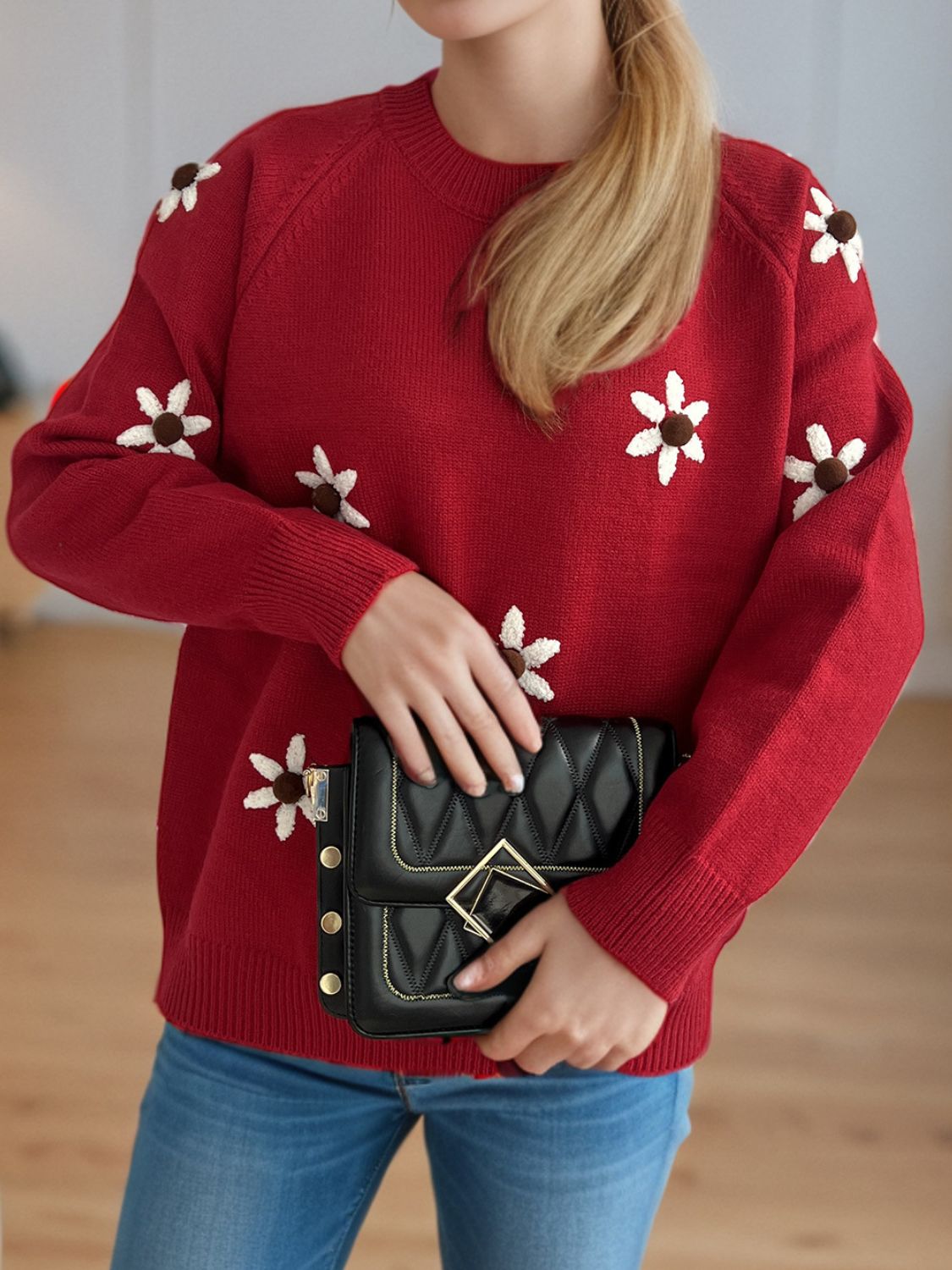 Burgundy embroidered floral raglan knit sweater with crewneck and long sleeves.