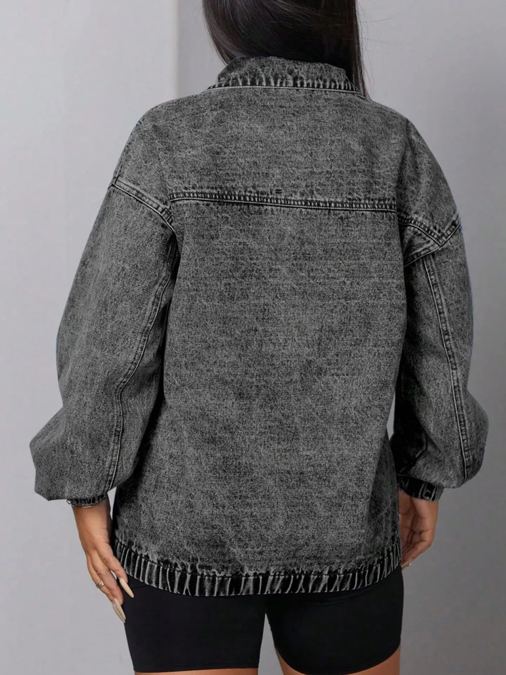 Dark gray acid wash denim sweatshirt with elastic hem and balloon sleeves.