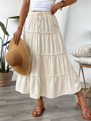 Textured tiered midi skirt in cream with drawstring waist and ruffled details.