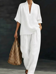 White half-sleeve top with V-neck and wide-leg pants set, casual women's outfit.