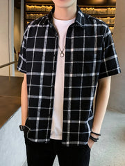 Men's black and white plaid short sleeve button-down shirt with chest pocket.