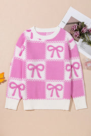 Fuchsia pink and white checkered bow jacquard knit sweater with crewneck and ribbed trim.