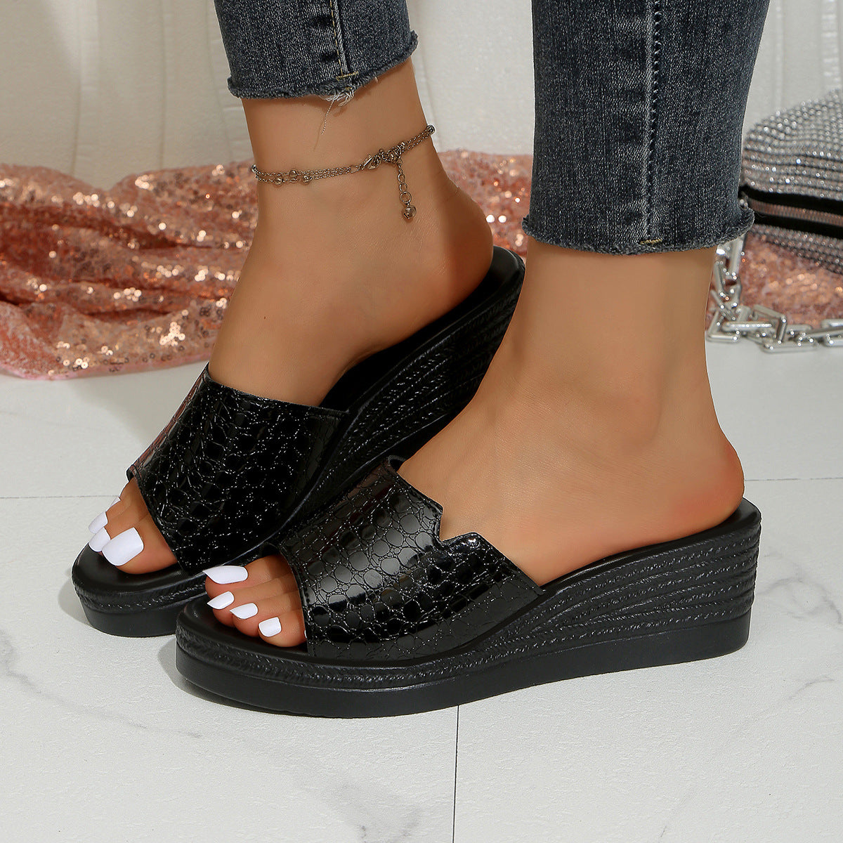 Black crocodile-embossed open-toe wedge sandals with a comfortable platform sole.