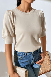 Cream knit sweater with puff sleeves and crew neck, styled with jeans.
