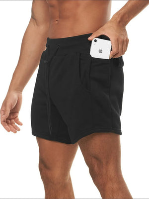 Black performance fleece jogger shorts with drawcord and side pocket holding a phone.