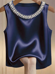 Dark blue satin tank top with pearl embellished neckline.