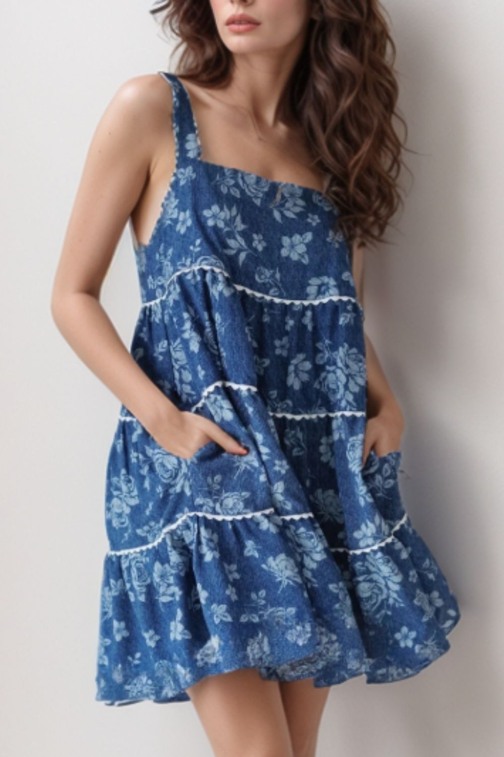 Floral denim tiered sundress with pockets in medium blue, featuring white trim and a casual fit.
