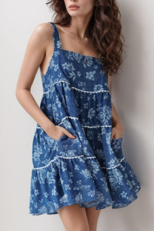 Floral denim tiered sundress with pockets in medium blue, featuring white trim and a casual fit.