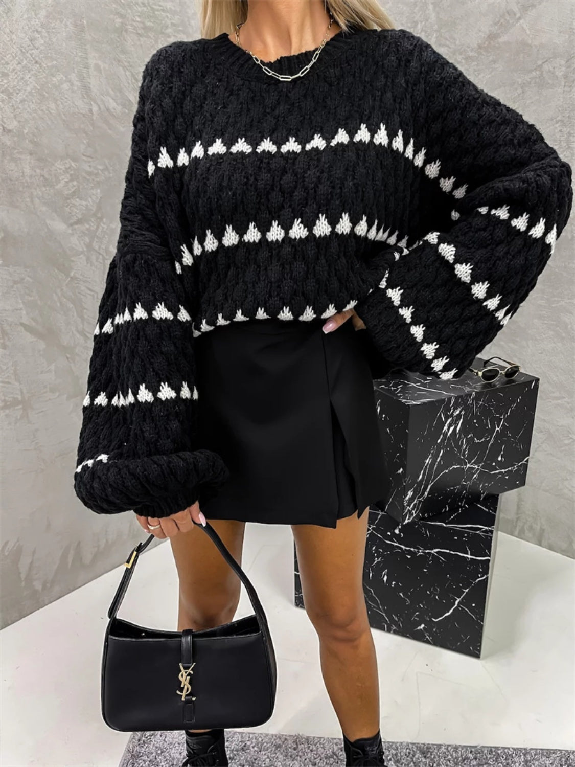 Black textured knit sweater with white stripe pattern and balloon sleeves