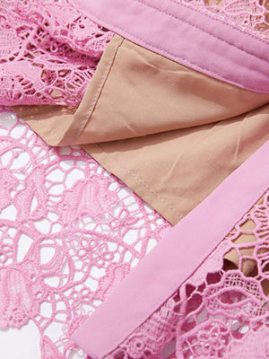 Pink lace midi dress with tan lining and pink trim detail.