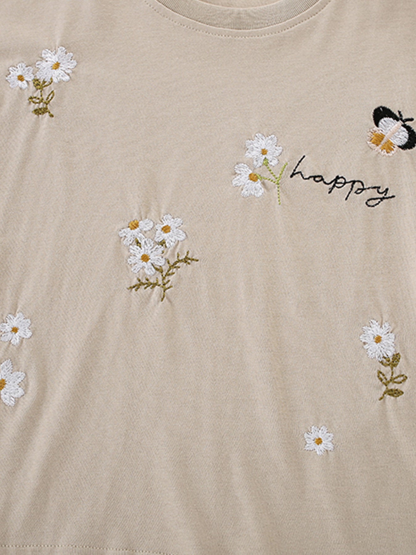 Beige cotton tee with embroidered daisies, butterflies, and "happy" text.