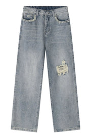 Distressed wide-leg jeans in medium wash denim with raw edge pockets and a ripped detail.