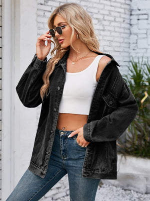 Black oversized denim trucker jacket with rolled sleeves and button details.