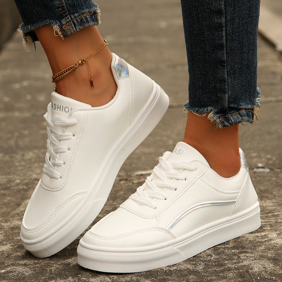 White lace-up casual sneakers with silver accents and a comfortable fit.