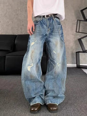 Distressed wide-leg denim jeans for men in light blue wash with chain detail.