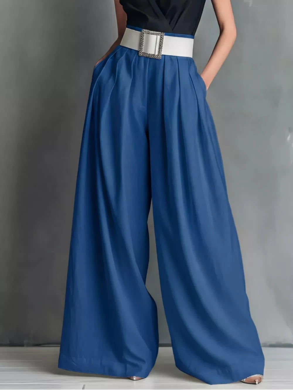 Blue belted high-waisted wide-leg maternity pants with a white buckle belt.