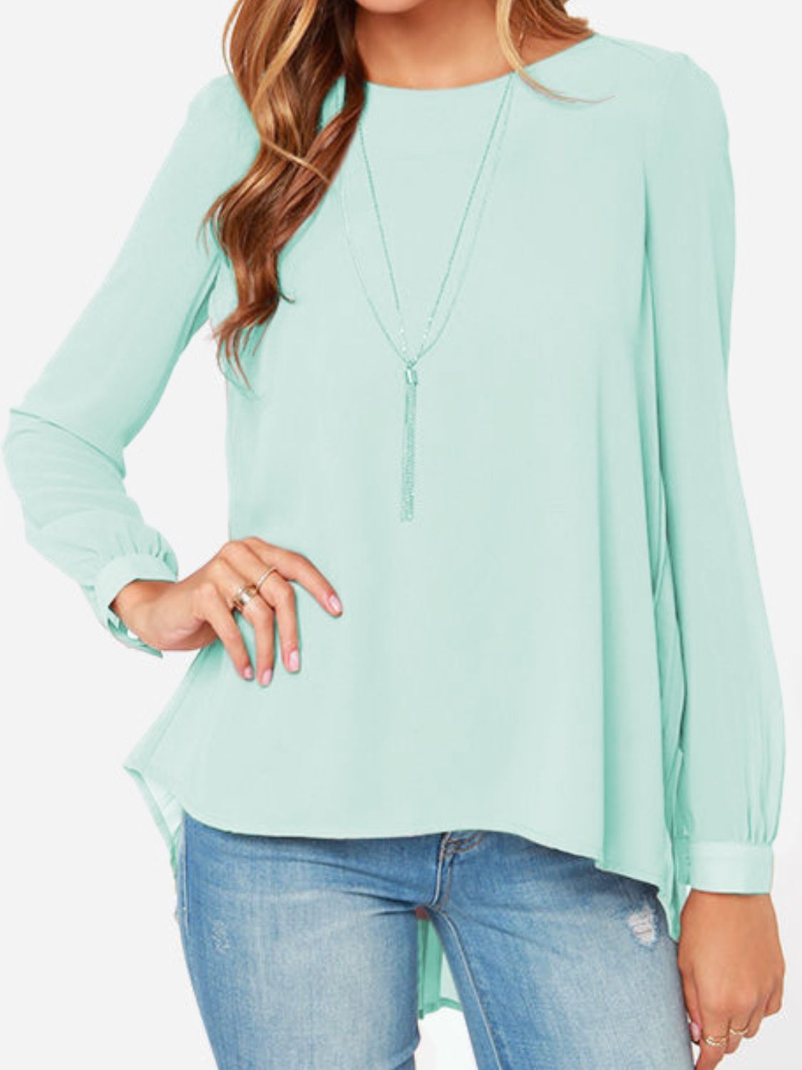 Light green long sleeve blouse with fluid silhouette and layered necklace.
