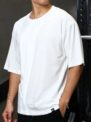 White oversized tee with raw edges and a crew neck.