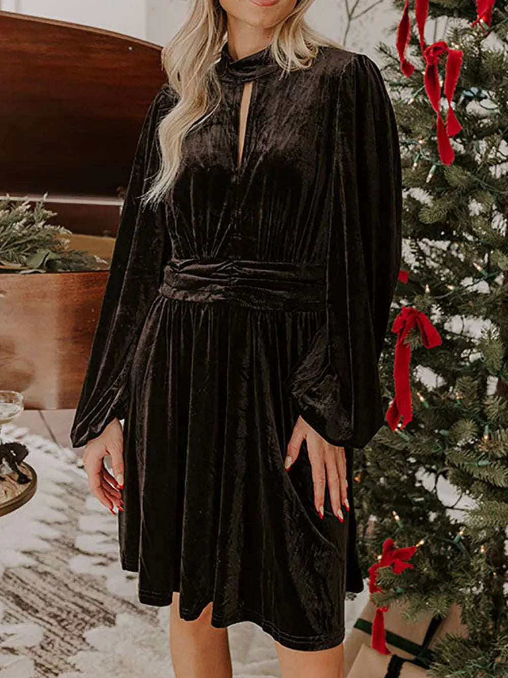 Black velvet mock neck dress with balloon sleeves and cinched waist detail