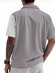 Men's light gray short sleeve button-down shirt with vertical pinstripe texture and color block white sleeve.
