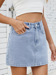 Light wash denim mini skirt with classic five-pocket styling and button closure.