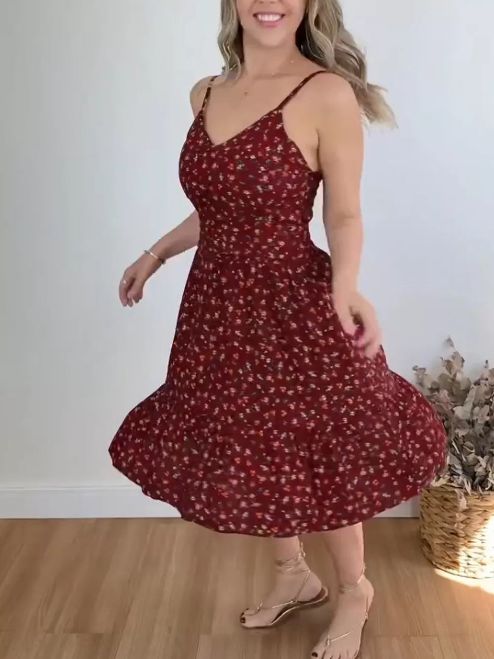 Charming floral print midi dress with spaghetti straps and ruffle hem.
