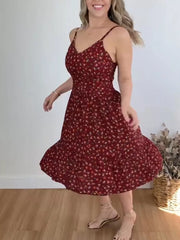Charming floral print midi dress with spaghetti straps and ruffle hem.