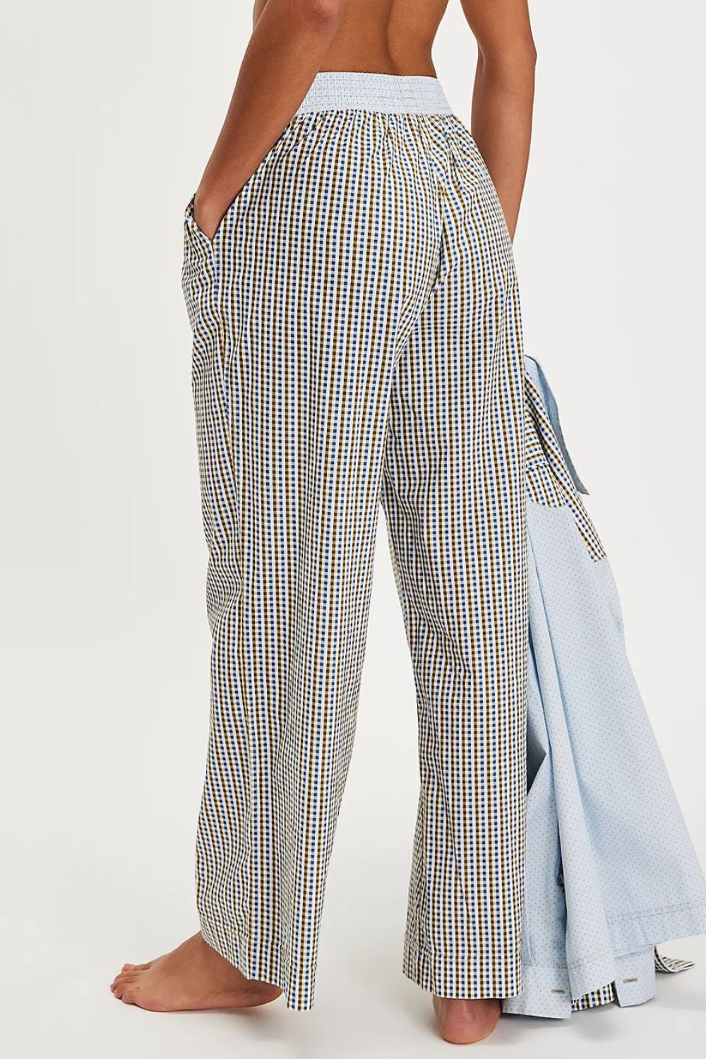 Gingham wide-leg lounge trousers in light gray with a blue waistband and pockets.