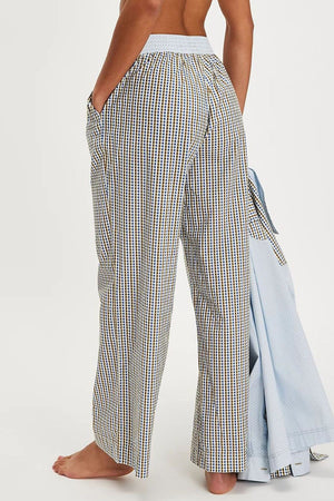 Gingham wide-leg lounge trousers in light gray with a blue waistband and pockets.