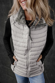 Gray quilted puffer vest with a fuzzy fleece collar and zip front.