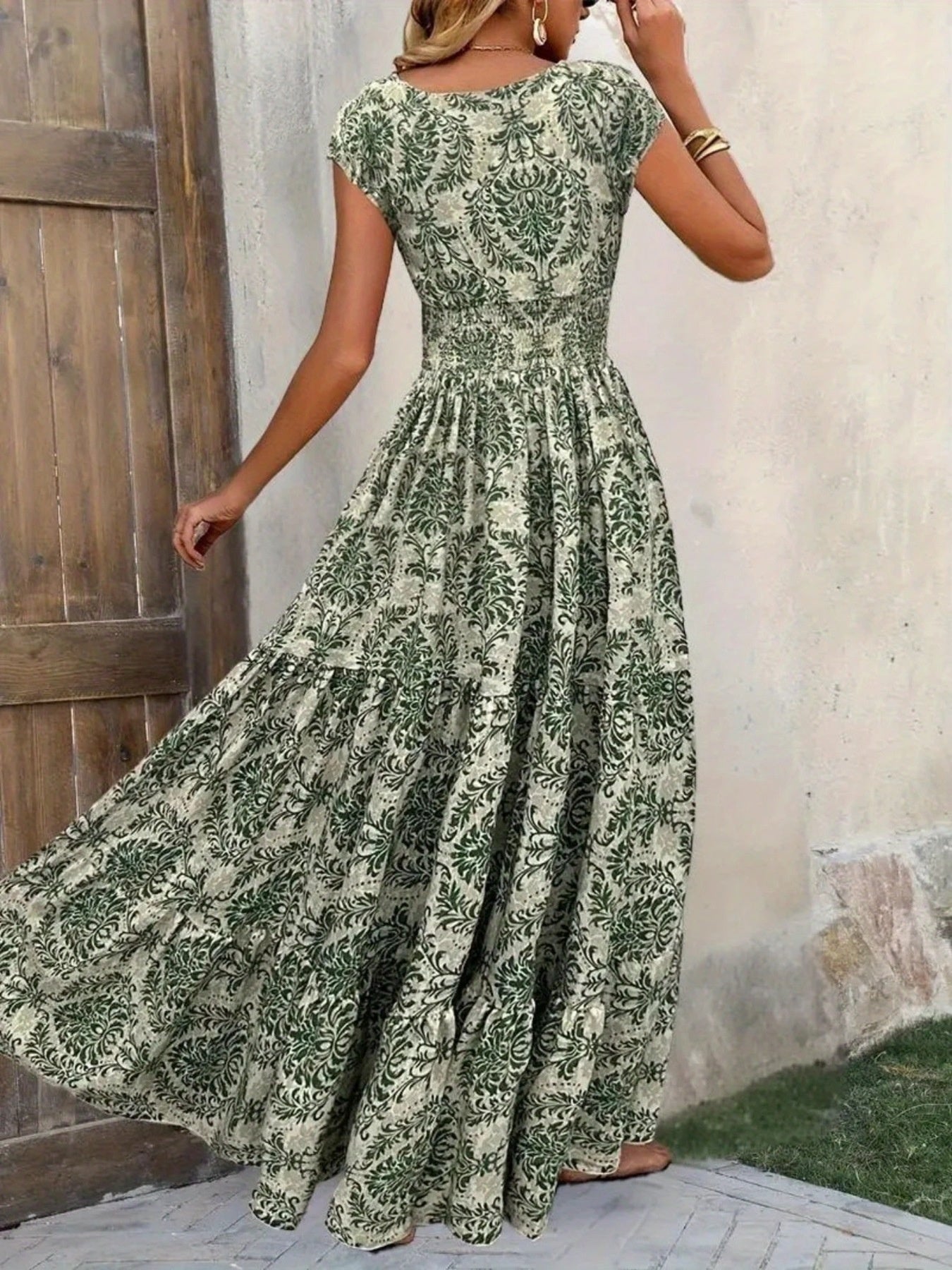 Green damask print maxi dress with cap sleeves and tiered skirt.