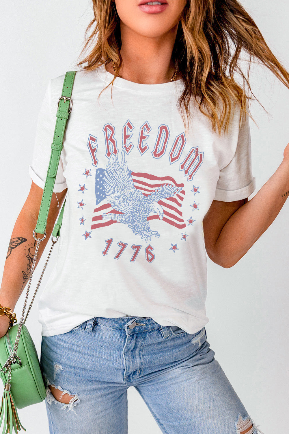 White graphic tee with eagle, American flag, and 1776 print