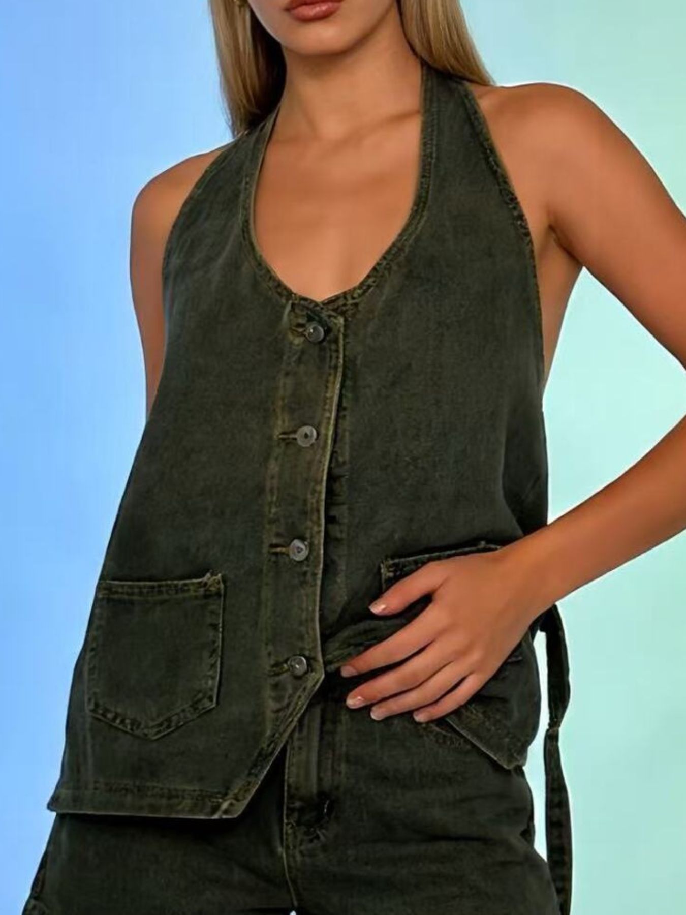 Button-down denim halter vest in dark green with V-neck and two front pockets.