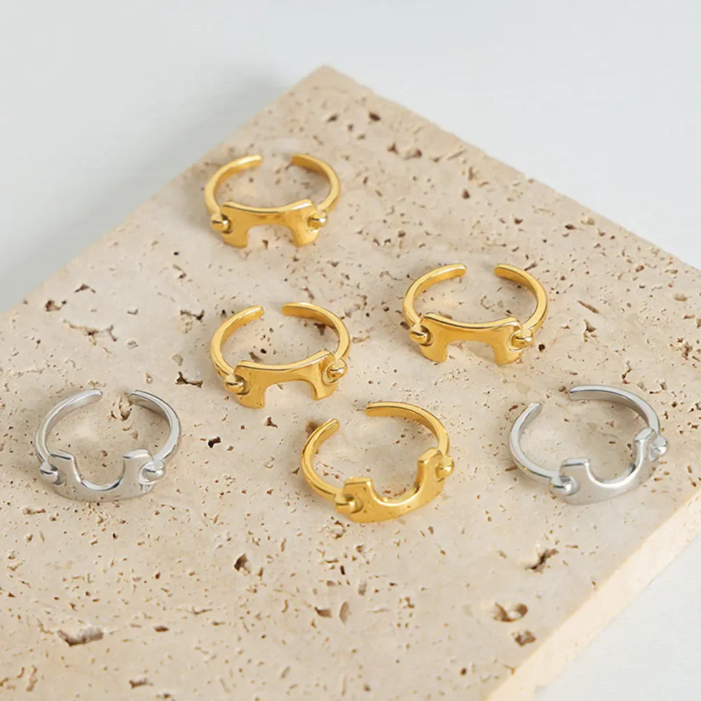 Sculptural gold and silver open-ended rings with unique asymmetrical design.
