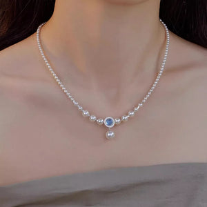 Luminous pearl choker with a blue stone pendant and dangling pearl, 925 silver.