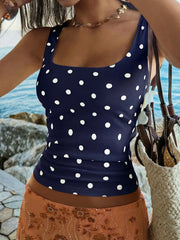 Navy blue polka dot scoop neck tank top with a cropped fit